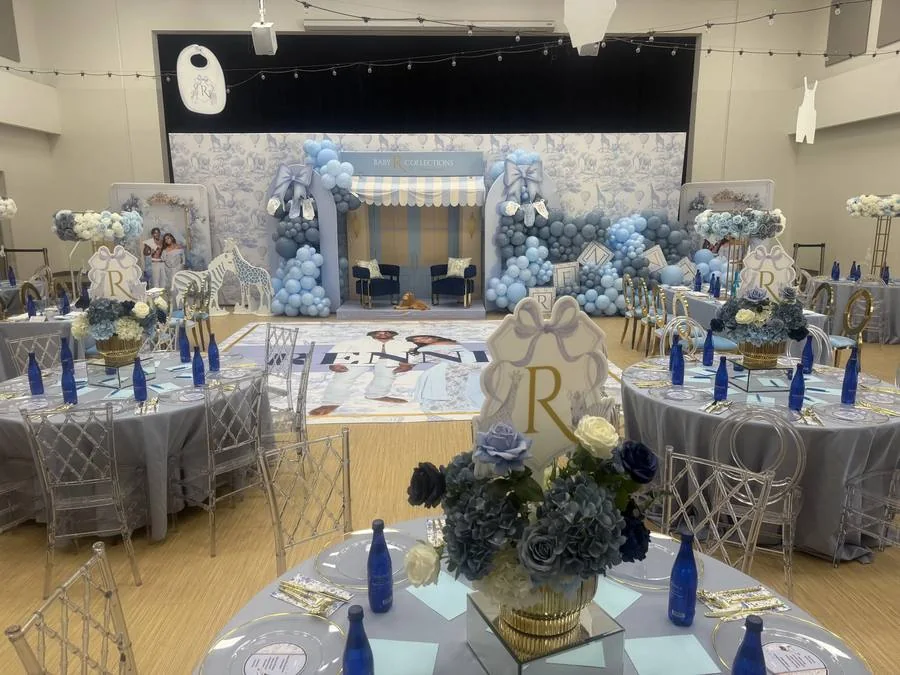 Blue and gold balloon decor around a birthday backdrop