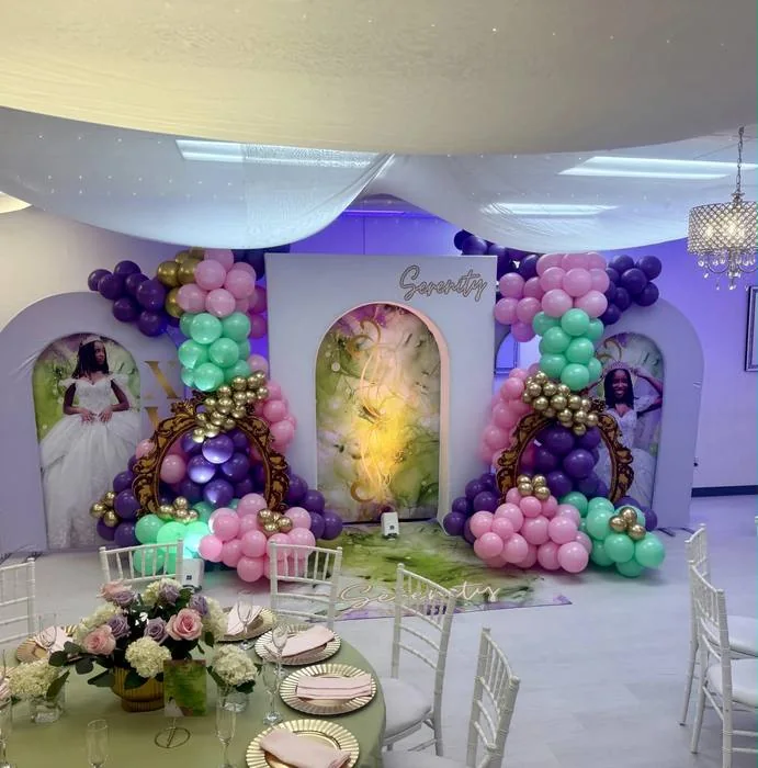 Purple and green balloon display with a gold framed backdrop